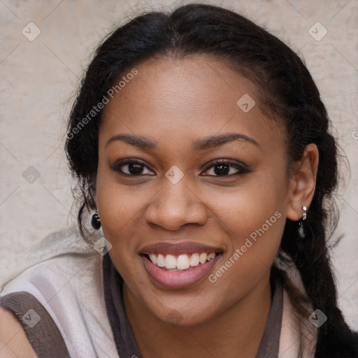 Joyful black young-adult female with long  brown hair and brown eyes