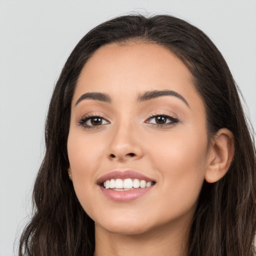 Joyful white young-adult female with long  brown hair and brown eyes