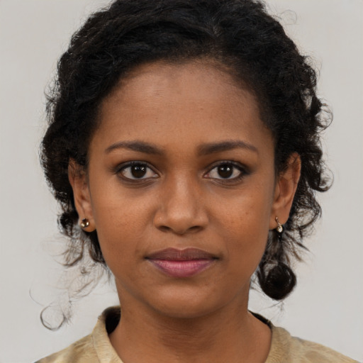Joyful black young-adult female with medium  black hair and brown eyes