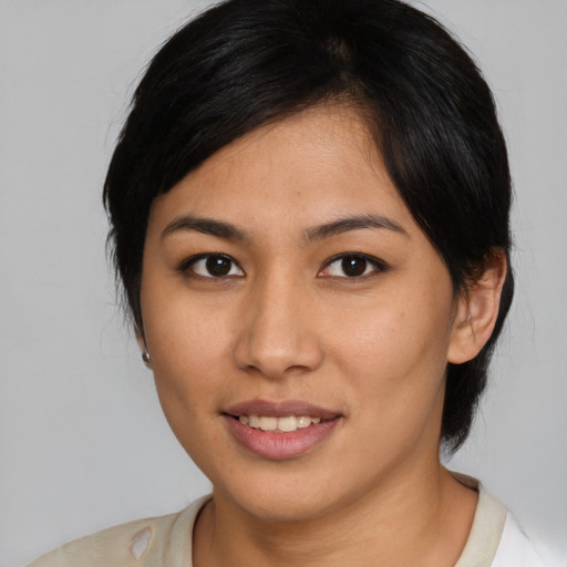 Joyful asian young-adult female with medium  brown hair and brown eyes