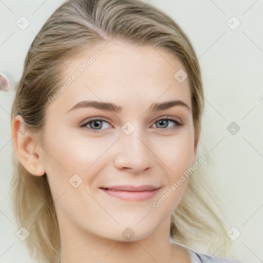 Joyful white young-adult female with long  brown hair and blue eyes