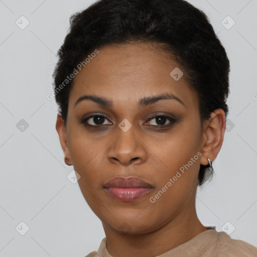 Joyful black young-adult female with short  black hair and brown eyes