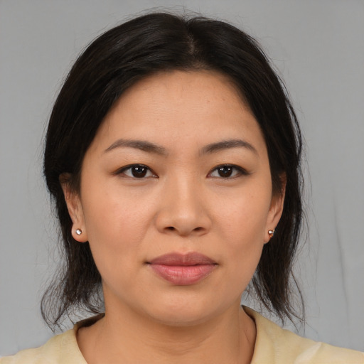 Joyful asian young-adult female with medium  brown hair and brown eyes
