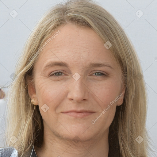 Joyful white adult female with long  brown hair and grey eyes