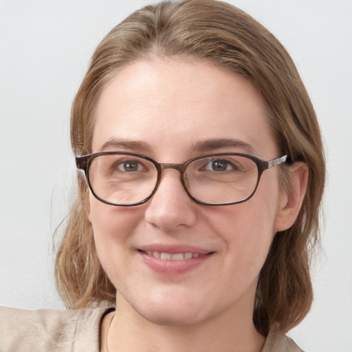 Joyful white young-adult female with medium  brown hair and blue eyes