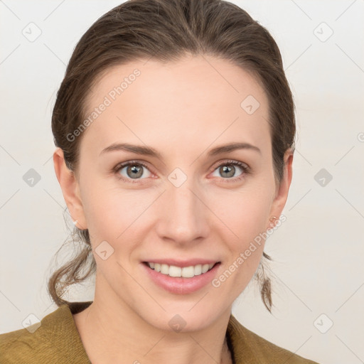 Joyful white young-adult female with medium  brown hair and grey eyes