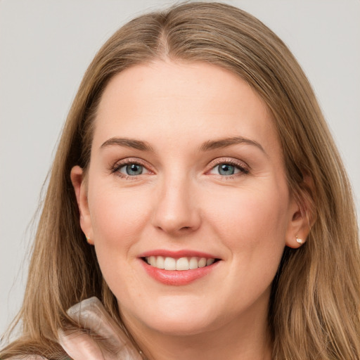 Joyful white young-adult female with long  brown hair and grey eyes