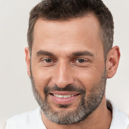 Joyful white adult male with short  brown hair and brown eyes