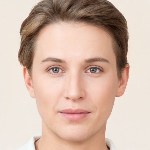 Joyful white young-adult female with short  brown hair and grey eyes