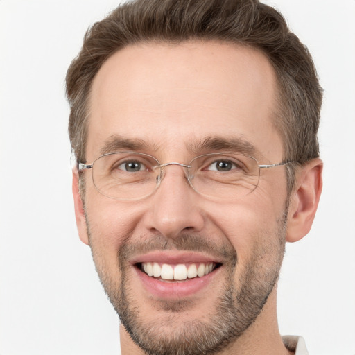 Joyful white adult male with short  brown hair and green eyes