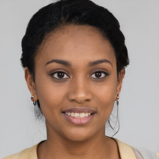 Joyful black young-adult female with short  black hair and brown eyes