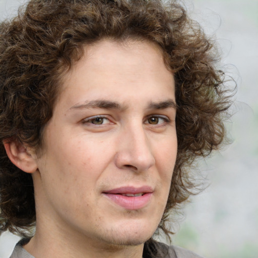 Joyful white young-adult male with medium  brown hair and brown eyes