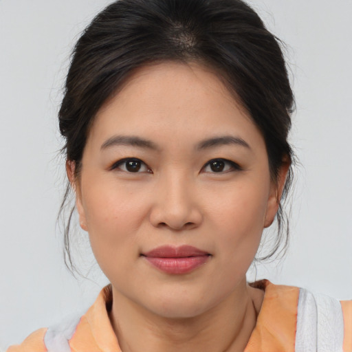 Joyful asian young-adult female with medium  brown hair and brown eyes