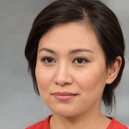 Joyful white adult female with medium  brown hair and brown eyes