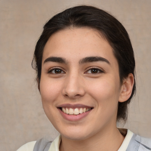 Joyful white young-adult female with medium  brown hair and brown eyes