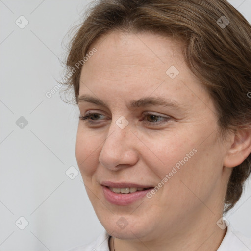 Joyful white adult female with medium  brown hair and brown eyes