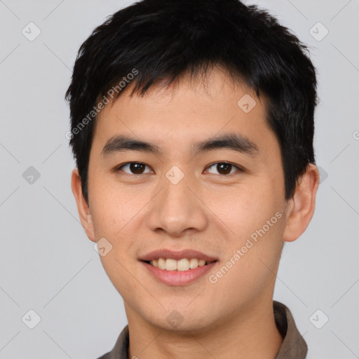 Joyful asian young-adult male with short  black hair and brown eyes