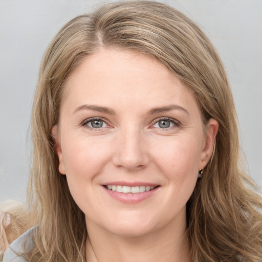 Joyful white young-adult female with long  brown hair and grey eyes