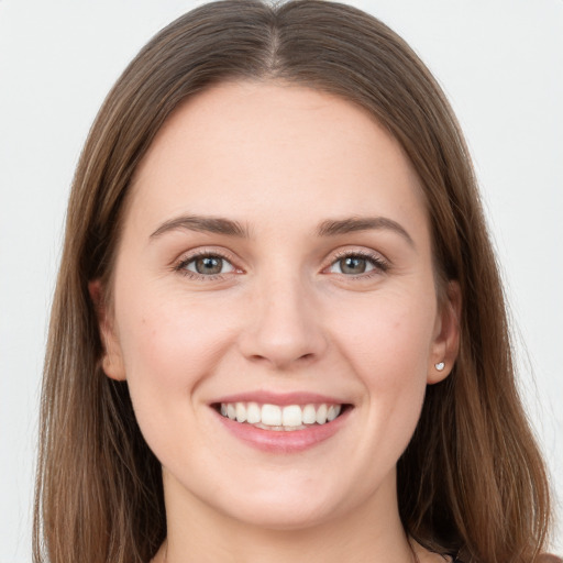 Joyful white young-adult female with long  brown hair and grey eyes