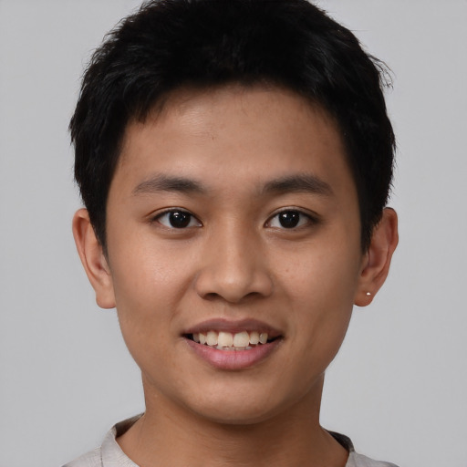 Joyful asian young-adult male with short  black hair and brown eyes