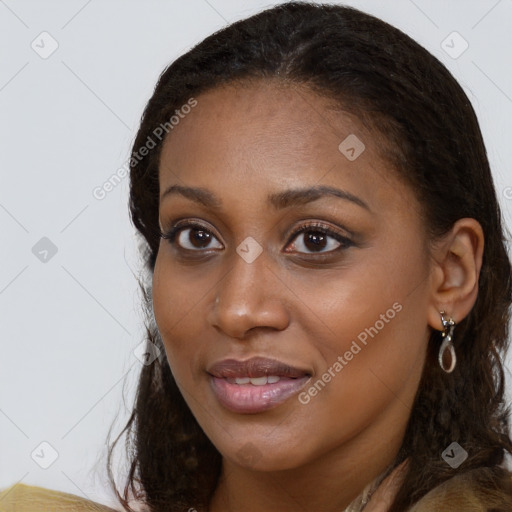 Joyful black young-adult female with long  brown hair and brown eyes