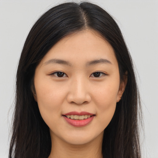 Joyful asian young-adult female with long  brown hair and brown eyes