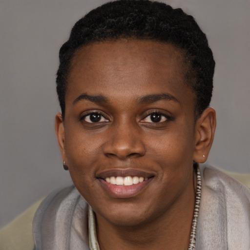Joyful black young-adult female with short  brown hair and brown eyes