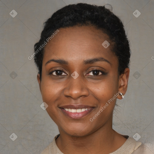 Joyful black young-adult female with short  black hair and brown eyes