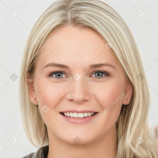 Joyful white young-adult female with long  brown hair and blue eyes