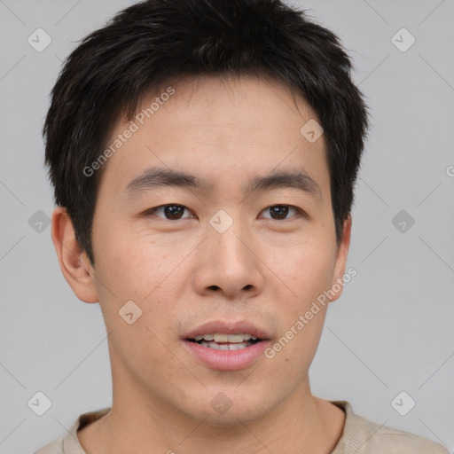 Joyful asian young-adult male with short  brown hair and brown eyes