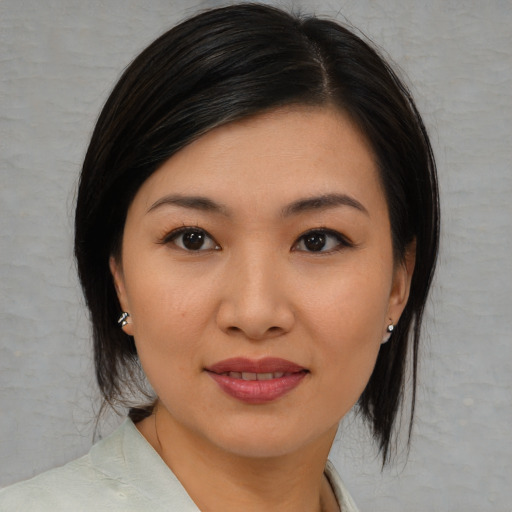 Joyful asian young-adult female with medium  black hair and brown eyes