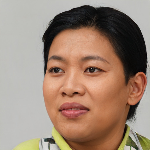 Joyful asian young-adult female with medium  brown hair and brown eyes