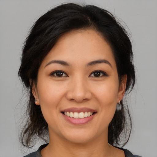 Joyful asian young-adult female with medium  brown hair and brown eyes