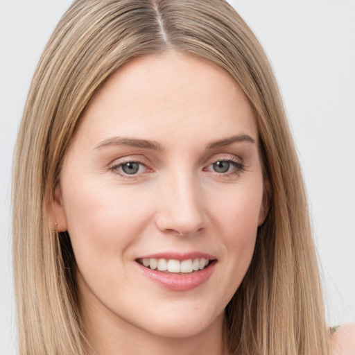 Joyful white young-adult female with long  brown hair and grey eyes