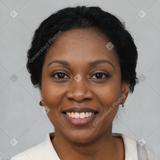 Joyful black adult female with short  black hair and brown eyes