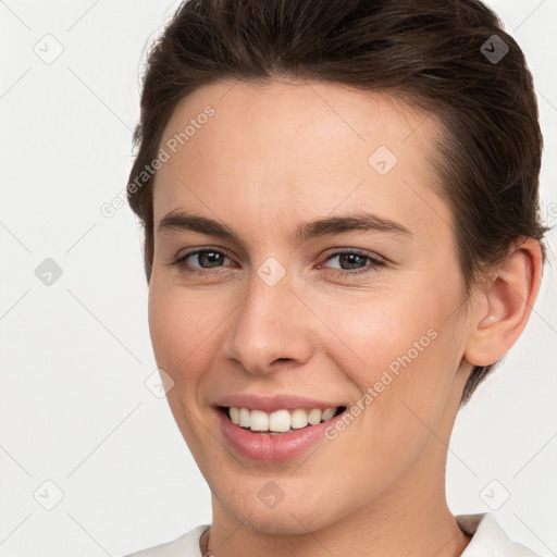 Joyful white young-adult female with short  brown hair and brown eyes