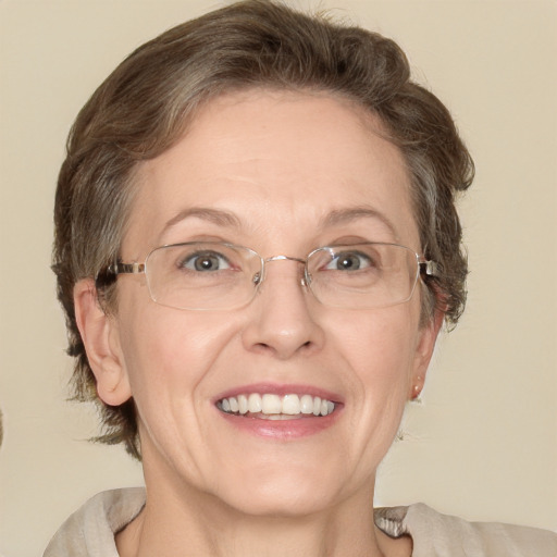 Joyful white adult female with medium  brown hair and green eyes