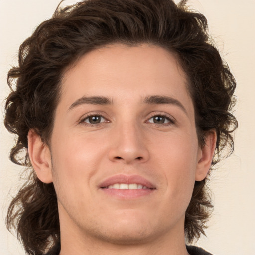 Joyful white young-adult male with medium  brown hair and brown eyes