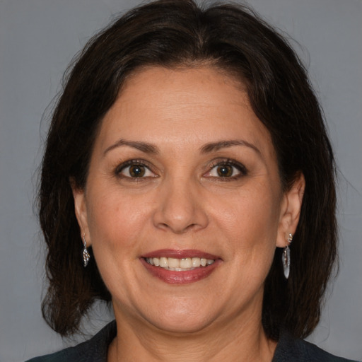 Joyful white adult female with medium  brown hair and brown eyes