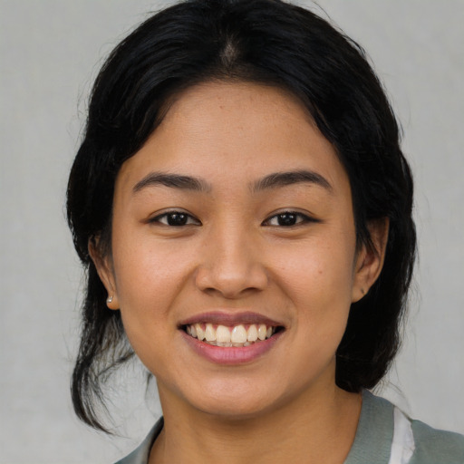 Joyful asian young-adult female with medium  black hair and brown eyes