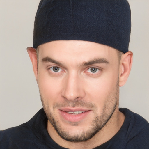 Joyful white young-adult male with short  brown hair and brown eyes