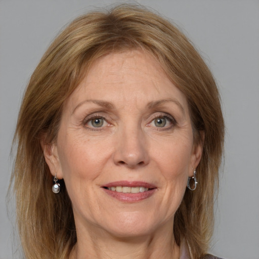 Joyful white adult female with medium  brown hair and grey eyes