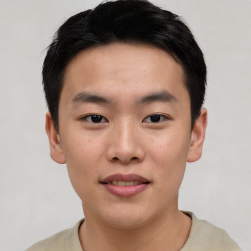 Joyful asian young-adult male with short  black hair and brown eyes
