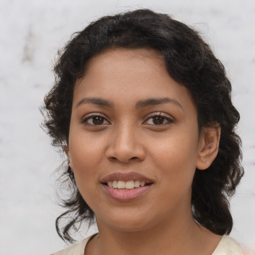 Joyful latino young-adult female with medium  brown hair and brown eyes