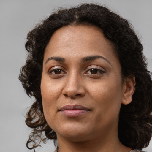 Joyful black young-adult female with medium  brown hair and brown eyes