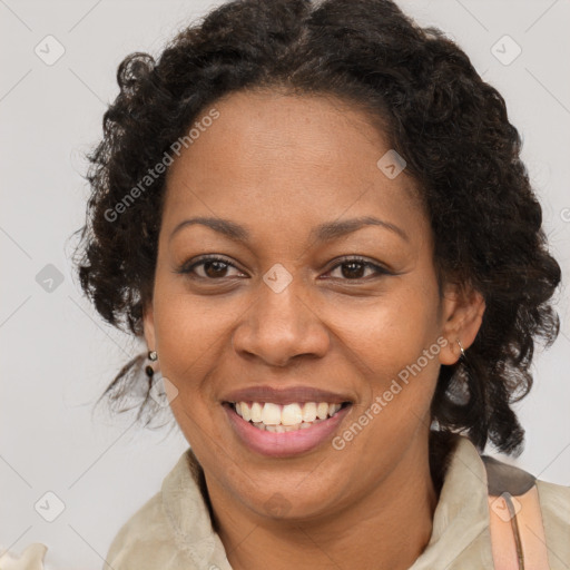 Joyful black adult female with medium  brown hair and brown eyes