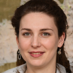 Joyful white young-adult female with medium  brown hair and green eyes