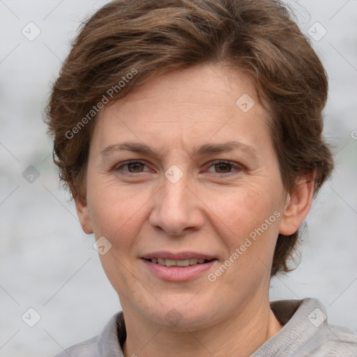 Joyful white adult female with short  brown hair and grey eyes