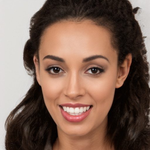 Joyful latino young-adult female with long  brown hair and brown eyes