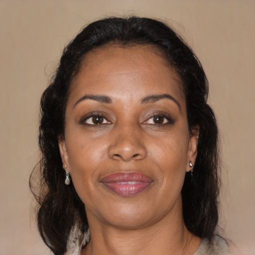 Joyful black adult female with medium  brown hair and brown eyes